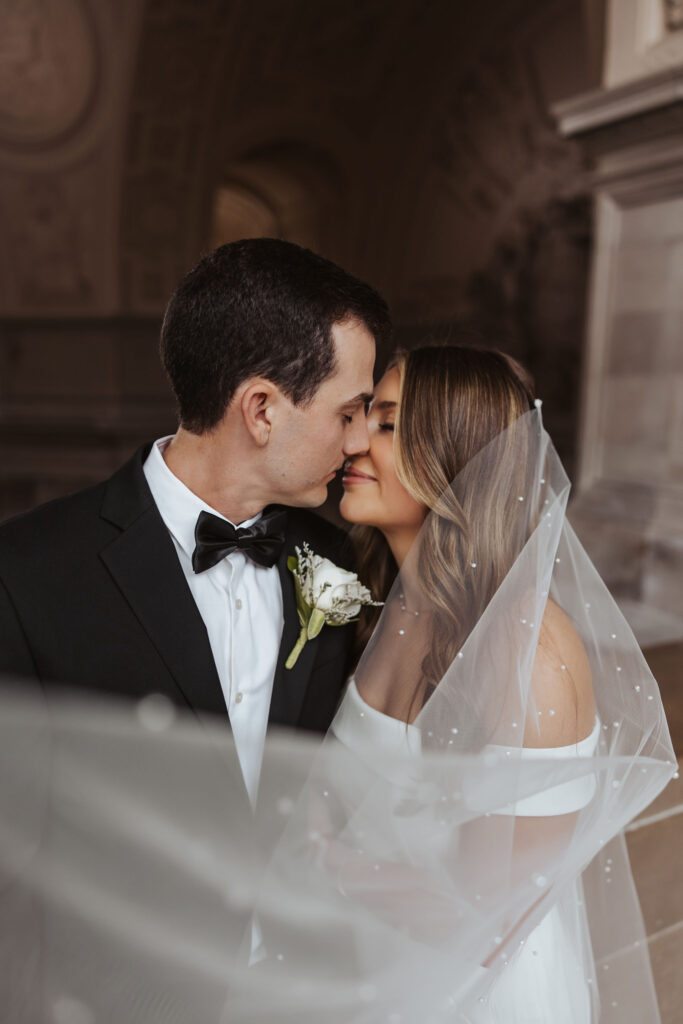 bride and groom wedding portrait with pearl veil