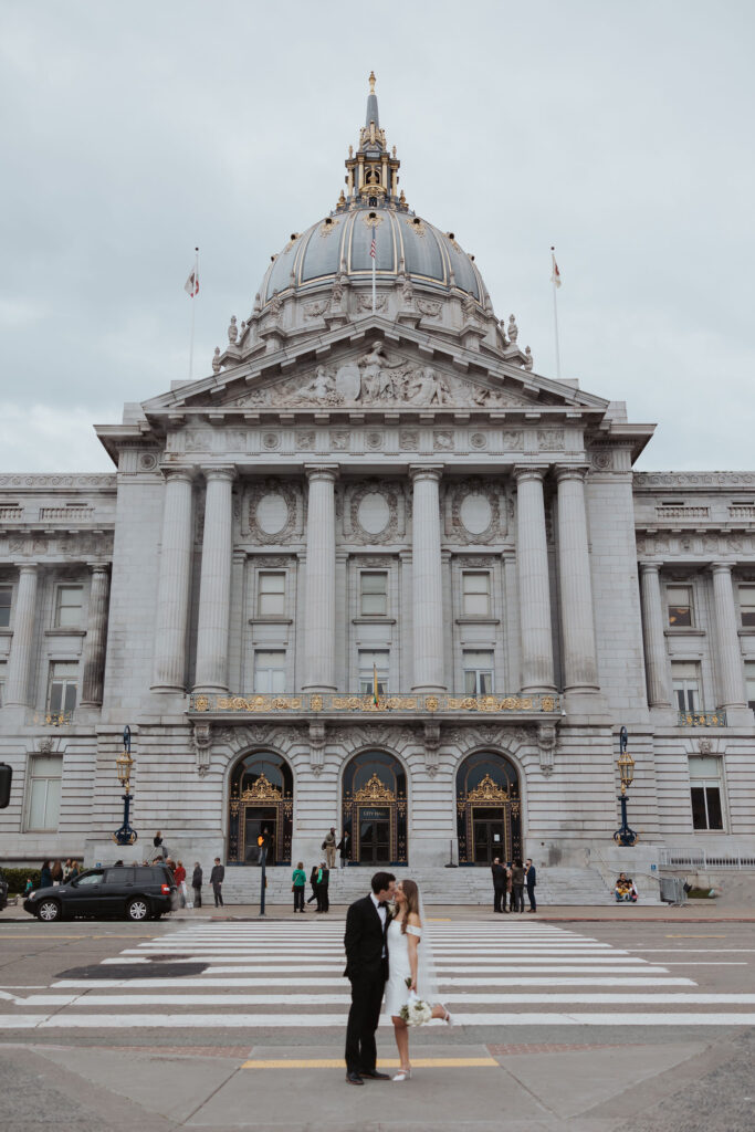 Bride and groom standing in front of San Francisco City Hall Wedding
