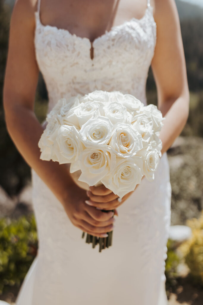 bride holding white wedding florals